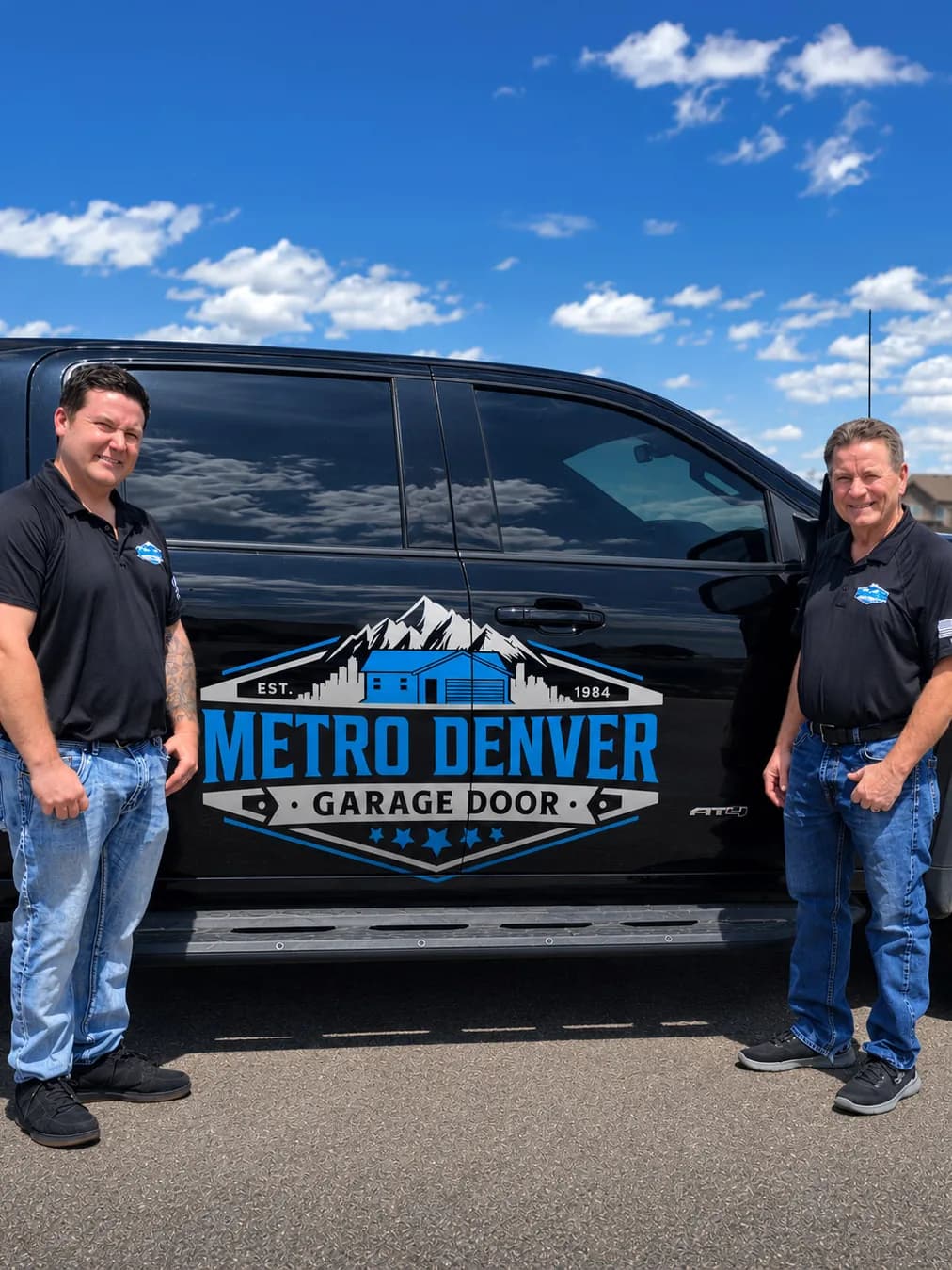 Randy Krouse and his son standing beside the Metro Denver Garage Door service truck