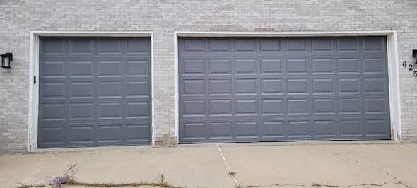 Dark gray paneled garage doors with clean horizontal lines