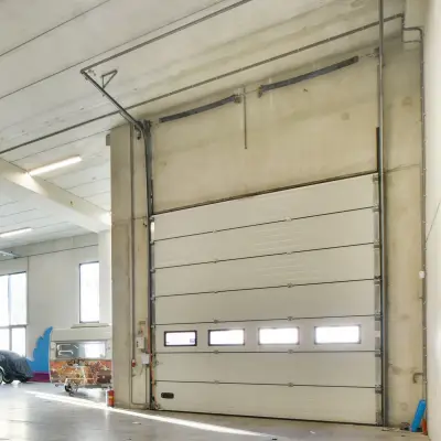 Technician Installing Garage Door Opener Adjusting Motor Mechanism with Remote Control.