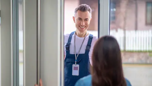 Professional in uniform with ID badge providing customer service