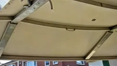 A view from inside a garage showing an uneven or sagging garage door.